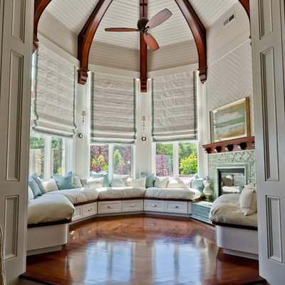 Living room - mid-sized traditional enclosed medium tone wood floor and brown floor living room idea in Salt Lake City with white walls, a standard fireplace and a tile fireplace