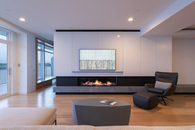 Mid-sized minimalist light wood floor living room photo in Cincinnati with white walls, a ribbon fireplace, a stone fireplace and a wall-mounted tv