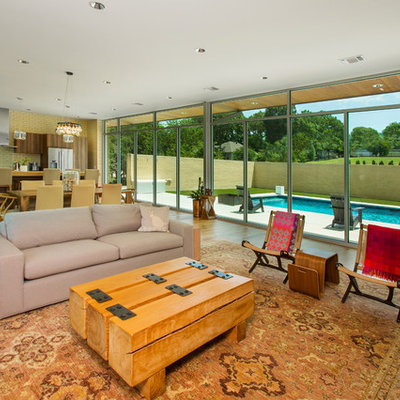 Example of a large 1950s open concept light wood floor and beige floor living room design in Dallas with white walls, a standard fireplace, a brick fireplace and a wall-mounted tv