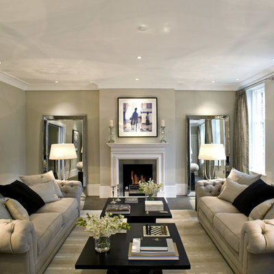 Inspiration for a transitional enclosed living room remodel in London with beige walls and a standard fireplace