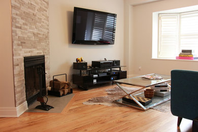 Example of a mid-sized trendy formal and open concept light wood floor living room design in Toronto with white walls, a standard fireplace, a stone fireplace and a wall-mounted tv