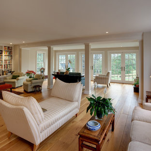 Inspiration for a huge timeless open concept medium tone wood floor living room library remodel in DC Metro with beige walls