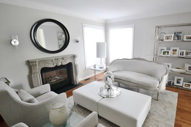 Example of a classic living room design in Ottawa with a standard fireplace and a concrete fireplace