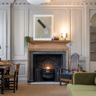 Inspiration for a large mediterranean formal open plan living room in Dorset with grey walls, carpet, a standard fireplace, a metal fireplace surround, no tv and brown floors.