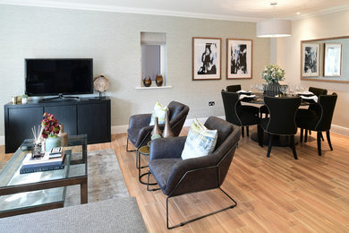 This is an example of a modern living room in London with porcelain flooring and brown floors.