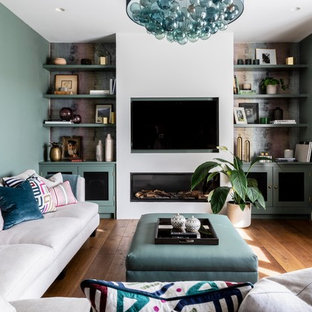 Photo of a contemporary living room in Other with green walls, medium hardwood flooring, a ribbon fireplace, a wall mounted tv and brown floors.