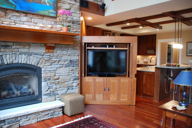 Example of a mid-sized transitional loft-style medium tone wood floor living room design in New York with a standard fireplace, a stone fireplace and a media wall