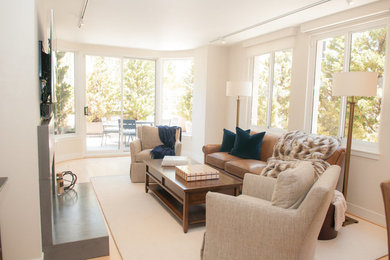 Example of a mid-sized transitional formal and open concept light wood floor and beige floor living room design in San Francisco with white walls, a standard fireplace, a concrete fireplace and a wall-mounted tv