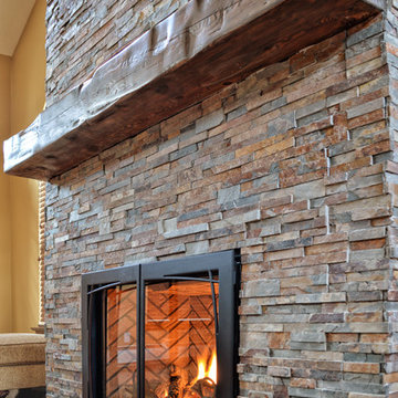 rustic fireplace in a room with high ceilings