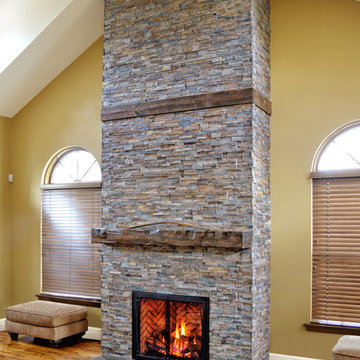 rustic fireplace in a room with high ceilings
