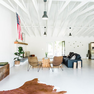 Inspiration for a large southwestern open concept concrete floor living room remodel in San Diego with white walls