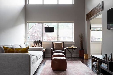 Example of a mid-sized mountain style loft-style dark wood floor living room design in New York with gray walls and a wall-mounted tv
