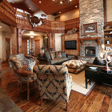 Rustic wood floors and stone fireplace