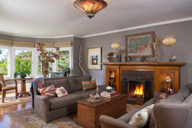 Inspiration for an eclectic living room remodel in San Francisco with gray walls, a tile fireplace and no tv