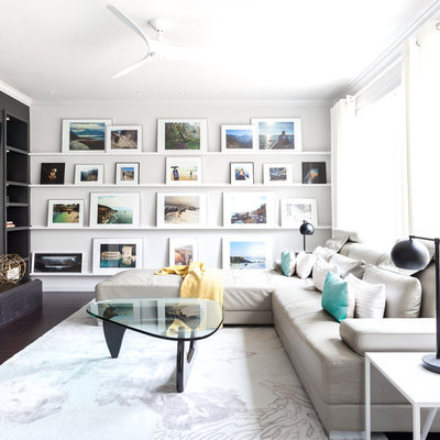 Example of a trendy formal dark wood floor living room design in Sacramento with black walls, a standard fireplace and a wall-mounted tv