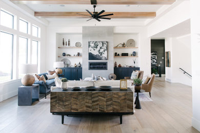 Example of a large transitional open concept light wood floor and beige floor living room design in Salt Lake City with white walls, a ribbon fireplace, a concrete fireplace and no tv