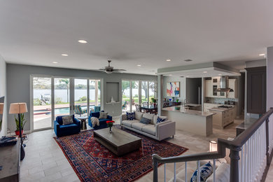 Large eclectic open plan living room in Tampa with grey walls, ceramic flooring, no fireplace and grey floors.