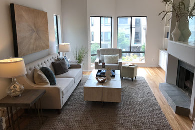 Example of a mid-sized trendy formal and enclosed medium tone wood floor and brown floor living room design in Portland with gray walls, a standard fireplace, a tile fireplace and no tv