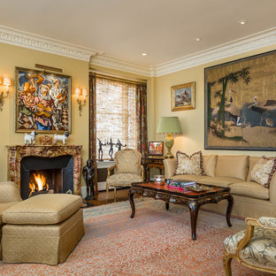 Living room - traditional formal medium tone wood floor and brown floor living room idea in San Francisco with yellow walls and a standard fireplace