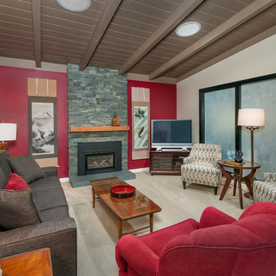 Asian carpeted living room photo in San Francisco with red walls, a standard fireplace, a stone fireplace and a tv stand