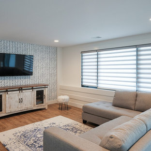 Example of a mid-sized beach style formal and open concept medium tone wood floor living room design in Grand Rapids with white walls and a wall-mounted tv