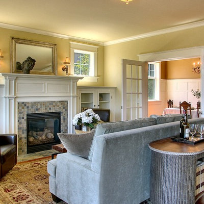 Example of a mid-sized classic medium tone wood floor living room design in Seattle with a tile fireplace, yellow walls and a standard fireplace