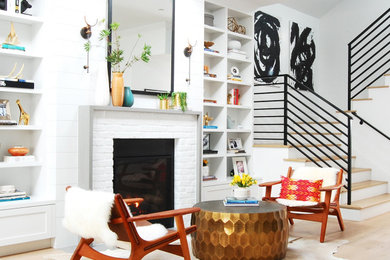 Foto de salón minimalista con suelo de madera clara, todas las chimeneas, marco de chimenea de ladrillo y machihembrado