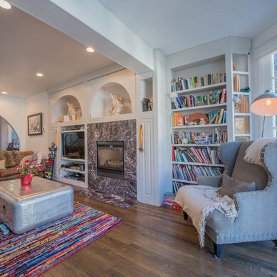 Example of an eclectic open concept dark wood floor and brown floor living room library design in Los Angeles with white walls, a standard fireplace and a tv stand