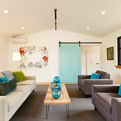 Example of a country medium tone wood floor living room design in Portland with white walls