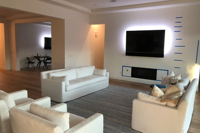 Example of a large minimalist formal and open concept light wood floor and beige floor living room design in Phoenix with white walls, a standard fireplace, a metal fireplace and a wall-mounted tv