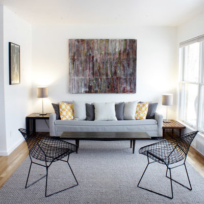 Living room - scandinavian formal light wood floor living room idea in Detroit with white walls