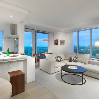 Example of a large danish open concept light wood floor living room design in Toronto with white walls, no fireplace and no tv