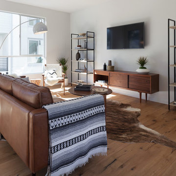 Scandinavian Modern Living Room With Leather Sofa and Cowhide Rug