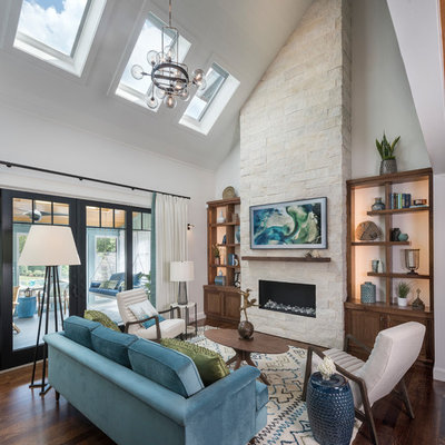 Inspiration for a contemporary open concept dark wood floor and brown floor living room remodel in San Diego with white walls, a ribbon fireplace and a stone fireplace