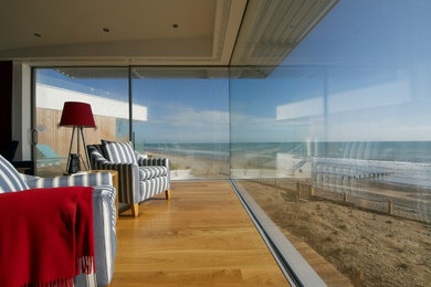 Inspiration for a coastal living room in Kent with medium hardwood flooring.