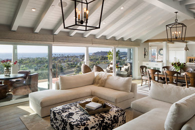 Example of a large transitional open concept medium tone wood floor living room design in San Diego with beige walls