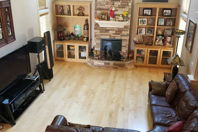 Large elegant open concept light wood floor living room photo in Boise