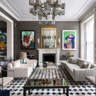 Design ideas for a classic formal open plan living room in London with grey walls, medium hardwood flooring, a standard fireplace, no tv and brown floors.