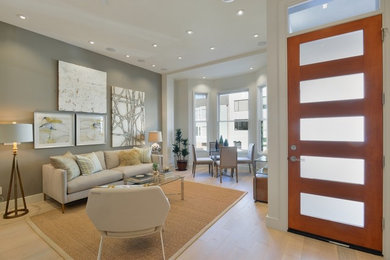 Example of a trendy open concept light wood floor living room design in San Francisco with gray walls