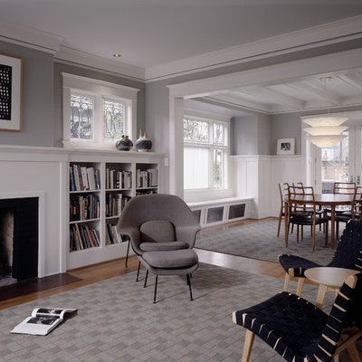 Mid-sized elegant formal medium tone wood floor living room photo in Seattle with gray walls, a standard fireplace and no tv