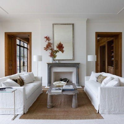 Inspiration for a transitional formal and enclosed medium tone wood floor living room remodel in Chicago with white walls, a standard fireplace, a stone fireplace and no tv