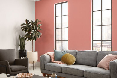 Идея дизайна: большая открытая гостиная комната в современном стиле с розовыми стенами, бетонным полом и серым полом без камина, телевизора