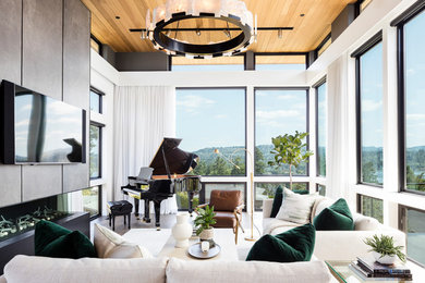 Example of a large minimalist open concept medium tone wood floor and brown floor living room design in Seattle with white walls, a ribbon fireplace, a concrete fireplace and a wall-mounted tv