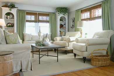 Example of a mid-sized classic open concept light wood floor living room design in New York with gray walls, no fireplace and no tv