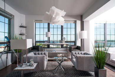 Foto di un soggiorno design di medie dimensioni e aperto con angolo bar, pareti grigie, pavimento in legno massello medio e pavimento beige