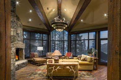 Example of a large mountain style formal and open concept medium tone wood floor living room design in Salt Lake City with a standard fireplace, a stone fireplace and no tv