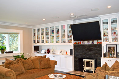 Example of a large formal and open concept dark wood floor living room design in New York with beige walls, a standard fireplace, a stone fireplace and a wall-mounted tv