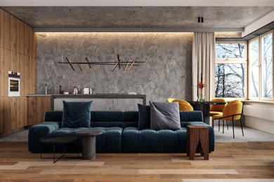 Imagen de salón abierto industrial sin chimenea con paredes grises, suelo de madera en tonos medios, televisor colgado en la pared, suelo amarillo y bandeja