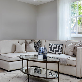 Inspiration for a classic living room in London with grey walls, light hardwood flooring and no fireplace.