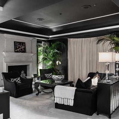 Living room - contemporary living room idea in Orange County with black walls and a standard fireplace